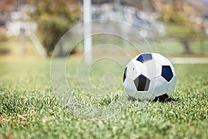 Soccer, sports and a ball on an empty pitch or field for fitness, exercise or training with a wellness lifestyle of