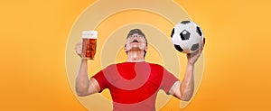 Soccer sports fan - happy man at oktoberfest, taking beer and soccer ball on yellow background.
