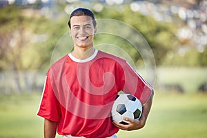 Soccer, sports and fitness with a man athlete holding a ball on a field or grass pitch for training. Football, workout