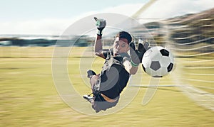 Soccer, sports and goalkeeper with a man saving a shot, goal or score during a game on a grass pitch field. Fitness