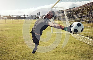 Soccer, sports and goalkeeper training on a field for a professional competition. Young and strong athlete with energy
