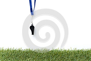 Soccer sports whistle on grass background - penalty, foul or sports concept