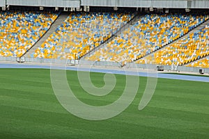 Soccer stadium inside view. football field, empty stands, a crowd of fans, a roof against the sky