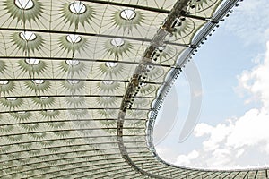 Soccer stadium inside view. football field, empty stands, a crowd of fans, a roof against the sky