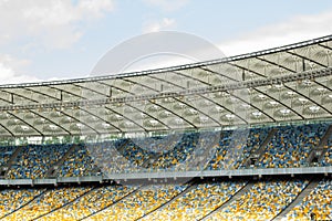 Soccer stadium inside view. football field, empty stands, a crowd of fans, a roof against the sky