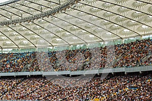 Soccer stadium inside view. football field, empty stands, a crowd of fans, a roof against the sky