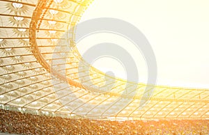 Soccer stadium inside view. football field, empty stands, a crowd of fans, a roof against the sky