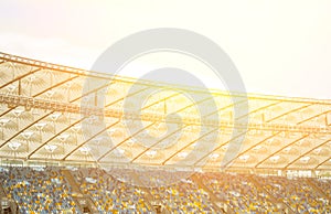 Soccer stadium inside view. football field, empty stands, a crowd of fans, a roof against the sky