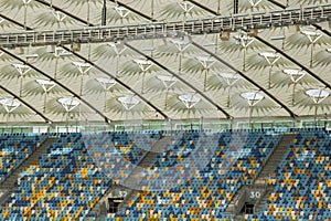 Soccer stadium inside view. football field, empty stands, a crowd of fans, a roof against the sky