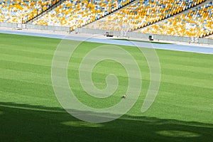 Soccer stadium inside view. football field, empty stands, a crowd of fans, a roof against the sky