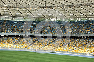 Soccer stadium inside view. football field, empty stands, a crowd of fans, a roof against the sky