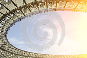 Soccer stadium inside view. football field, empty stands, a crowd of fans, a roof against the sky