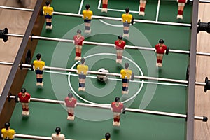 Soccer table game with red and yellow players close-up