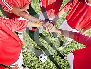 Soccer, team and hand in stack on field for motivation, support and teamwork at game, contest or match. Football, group