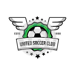 Soccer team logo with a ball and wings on a green background.Badge football team. Ball, stars, wings, shield, green lawn