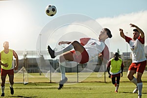 Soccer team, man and ball kick in air during football match, competition or training. Sports, fitness and soccer players
