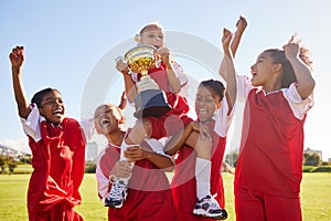 Soccer, team and trophy with children in celebration together as a girl winner group for a sports competition. Football