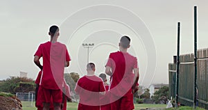 Soccer team, walking or men training on a field for sports game, group workout or football fitness. People, back or
