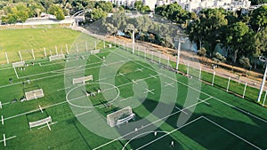 Soccer training on green field in tel aviv. Kid Football players running around the football field.