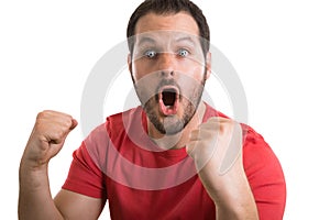 Soccerball fan with red shirt celebrating the success of his team