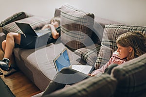 Social alienation of teenagers. Two children using a laptop computer photo
