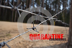 Social distance during quarantine and isolation. Closed territory with barbed wire. Barbed wire on a background of nature