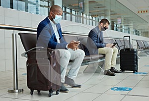 Social distance, suitcase and businessmen waiting in the airport and networking with cellphone. Face mask, luggage and