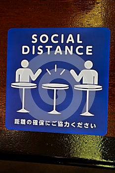 Social Distance word sticker on the table