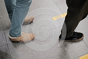 Social distancing of people waiting for buy a ticket and train concept at subway station