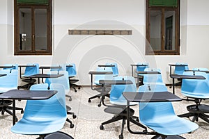 Social distancing between school desks in an empty classroom