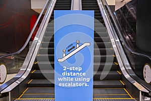 Social distancing sign for warning to keep social distance between each other to protect Coronavirus CoVID-19 when on escalators