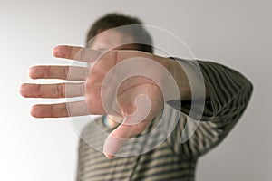 Social distancing during virus outbreak concept, man gesturing stop sign