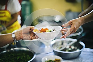 Social hunger: Volunteers provide food assistance to poor people who need food photo