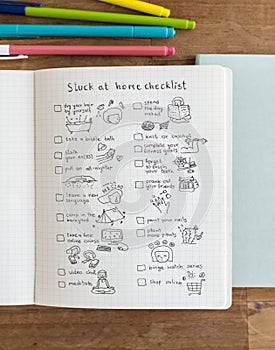 Social isolation doodle style checklist in a notebook