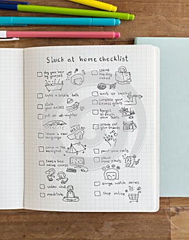 Social isolation doodle style checklist in a notebook photo