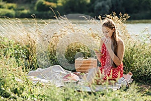 Social media internet addiction, phubbing. Young woman reading social media on their smart phones outdoor summer day