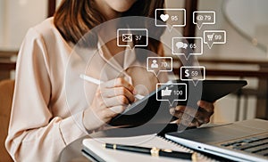 Social media and Marketing virtual icons screen concept.close up of businesswoman typing keyboard tablet with laptop computer