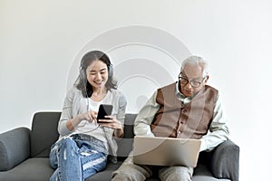 Social media network addiction, Family relationship conflict, Senior asian old father and daughter busy with their smartphone.