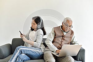 Social media network addiction, Family relationship conflict, Senior asian old father and daughter busy with their smartphone.