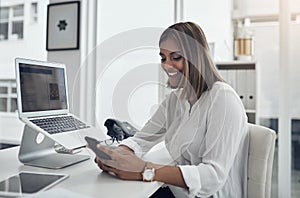 Social media is part of our marketing strategy. an attractive young businesswoman sitting alone in her office and using