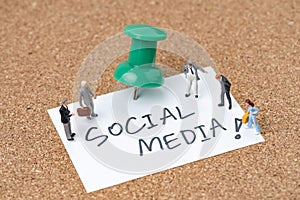 Social media people or social network concept, miniature people men and women standing on small paper note written the word Social