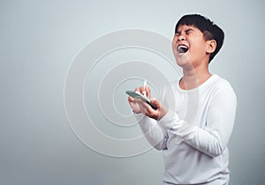 Social media and technology concepts. Boy hands holding a smartphone and stylus pencil to use multimedia and social media to