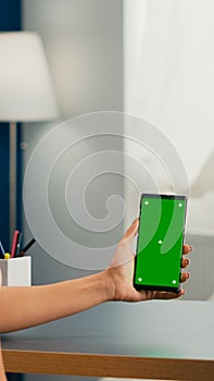 Social media woman holding touchscreen phone with mock up green screen