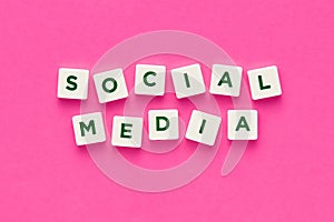 Social media written with letters on pink background