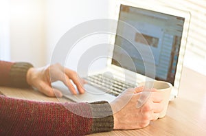 Social network user man working from home using notebook computer, selective focus