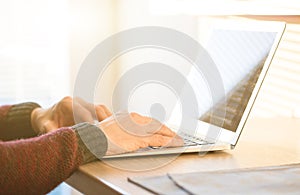 Social network user man working from home using notebook computer, selective focus
