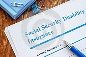 Social Security Disability Insurance SSDI application form and pen.