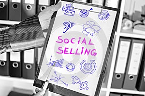 Social selling concept on a clipboard