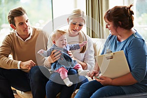 Social Worker Visiting Family With Young Baby