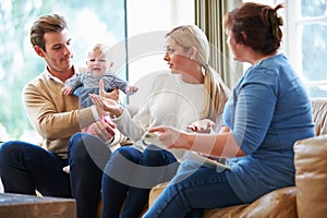 Social Worker Visiting Family With Young Baby